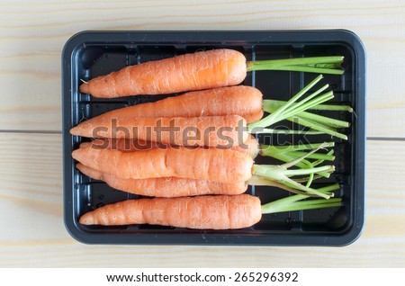 Close up of baby carrots in a black container