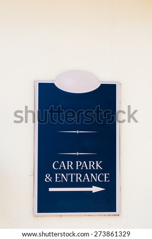 Sign for Car Park and Entrance on a wall