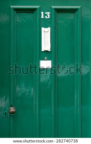 Green Painted Door number 13 thirteen with blank label under spyhole detail