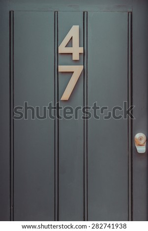 Door number 47 fourty seven vertical image closeup