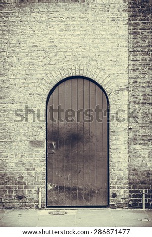 Vignette effect image of a weathered black door closeup