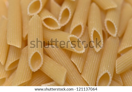 Pasta Penne texture background. Pasta is a staple food of traditional Italian cuisine.