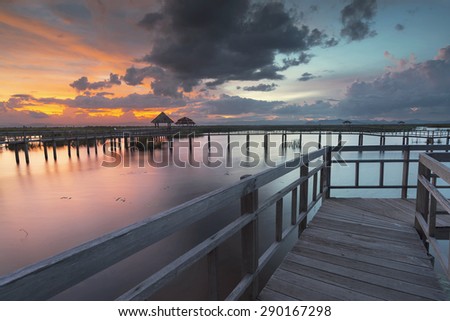 Wooden Bridge in lotus lake on sunset time at Khao Sam Roi Yot N