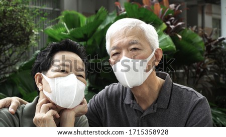 Similar – Image, Stock Photo Senior couple wearing protective face masks outdoors