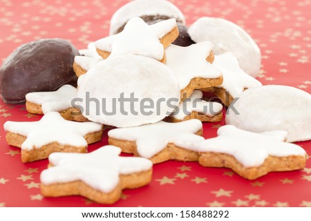 Mixed christmas biscuits on red background with golden stars