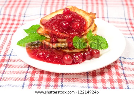 sweet pancakes with jam and mint leaves