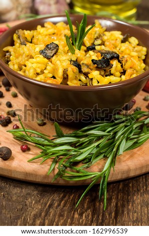 mushroom risotto with rosemary on wooden board