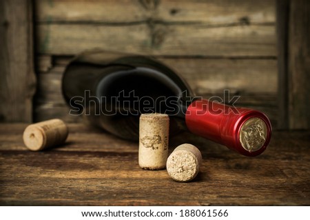 bottle of red wine with corks