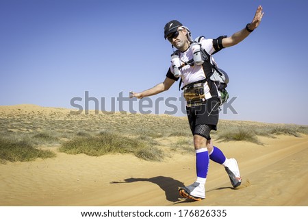 OMAN - JANUARY 29: Unidentified runner running in Omani desert on extreme marathon, on January 29, 2014. Transomania is one of the most extreme marathons ever, with 300 km in mountains and desert.