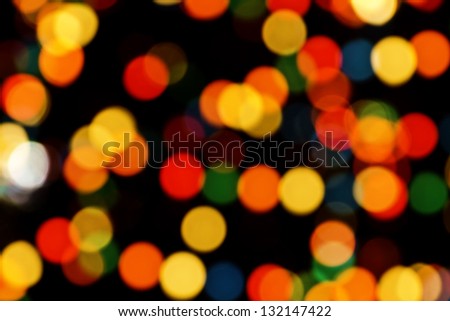 Multicolored Christmas tree lights bokeh sparkling background at night