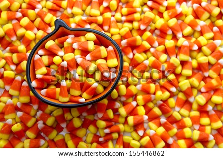 Candy corn candies in orange pumpkin bowl