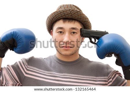 A young guy in a hat and boxing gloves commits suicide with gun