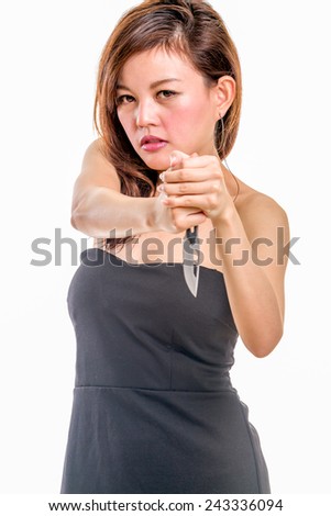 Chinese woman in a black dress holding a  knife in stabbing pose