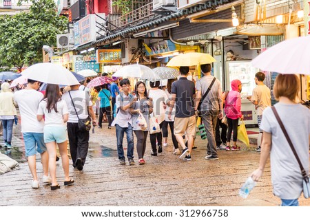 NEW TAIPEI CITY, TAIWAN - AUGUST 30, 2015: People walking around pedestrian shopping area by Danshui Old Street and Waterfront