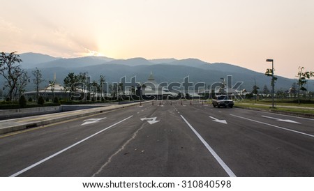 Sunset Car on Road with building and mountain