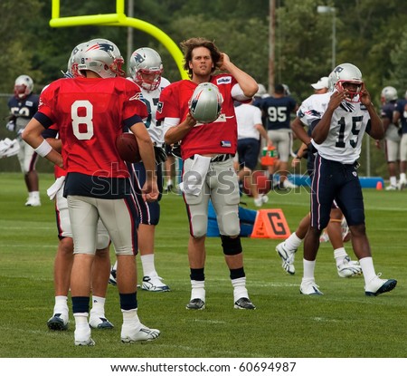 FOXBOROUGH, MA - AUGUST 6: Tom Brady has a break during a practice at the training camp in Foxborough MA. August 2010. Tom Brady is in the center of the image has his helmet ind right hand.