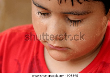Close-up of a young hispanic kid with his face all wet (very sharp image)