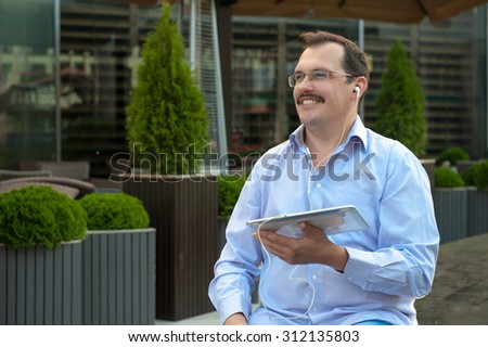 Man using tablet computer with high speed internet outdoors