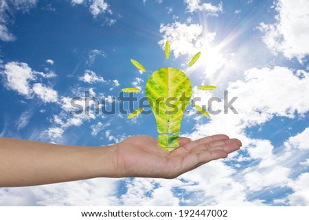 Light bulb made of green leaf on woman hands  Green eco energy concept.