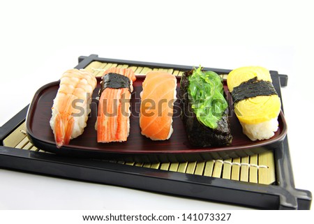 Mix Sushi on Black bamboo dish and Sushi is food of Japanese.