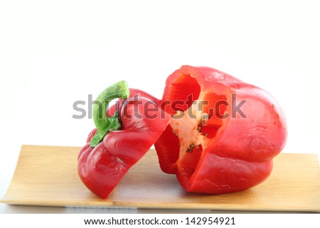Red bell pepper to Sliced in bamboo dish on white background.