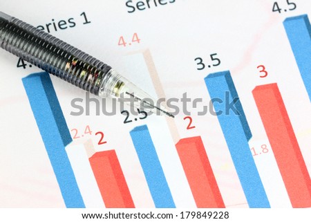 Closeup Mechanical pencil point to Numbers text on color bar graph.