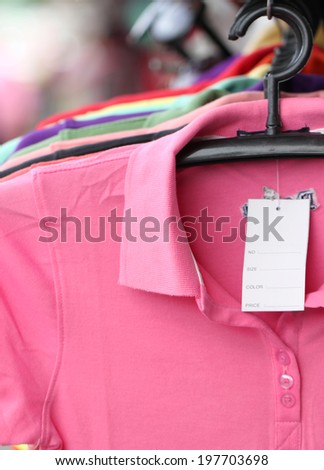 Pink shirt on a hanger in shop.