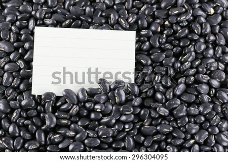 pile black beans and note paper for food background.