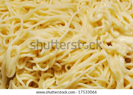 Hot spaghetti with processed cheese.