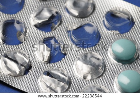 Partially used blue tablets. Close-up. Narrow depth of field.
