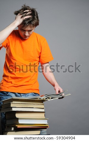 Man with big pile of old big books.