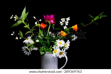 Bouquet in a vase on a black background.