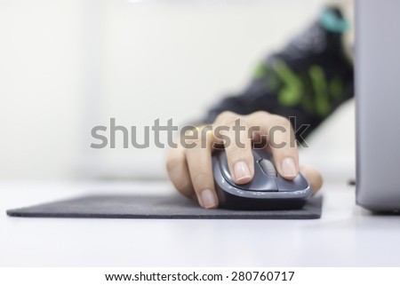 Closeup of woman hand clicking mouse