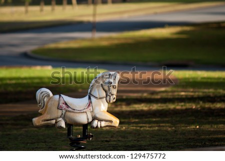 White Rocking horse on the playground.
