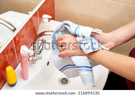 hygienic hand washing in the bathroom, toweling hands after washing