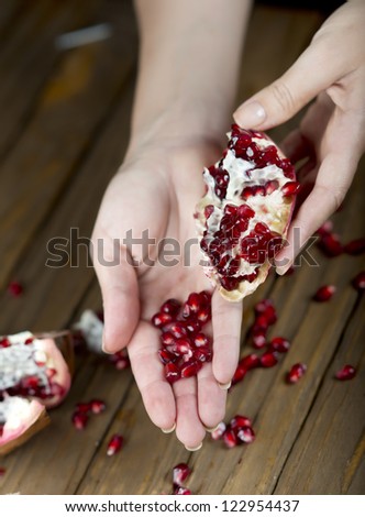 Pomegranate fruit on the table, sliced ??pomegranate on a plate, peel a pomegranate,