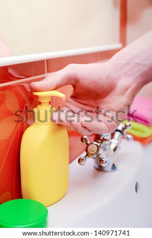 washing hands in bathroom.Wash basin with mixer tap and towels