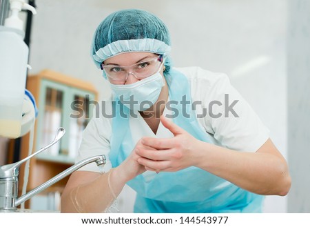 Beautiful nurse, washes his hands before the procedure,wiped his hands dry. midwife washes his hands before delivery. surgical hand washing