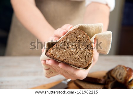 bread. woman\'s hands cut bread