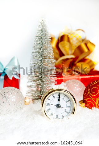 New Year\'s clock. Christmas clock and fir branches covered with snow