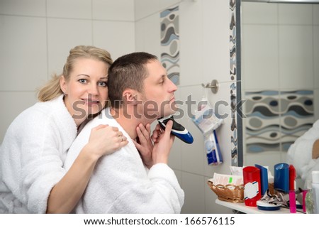 Fashion portrait of Young handsome man. male chin and electric shaver