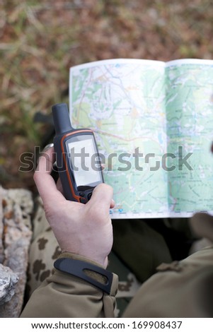 Man holding a GPS receiver in his hand. GPS map