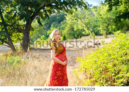 Pregnant woman in the park.Indian girl in dress