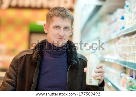 man buys dairy products at the supermarket
