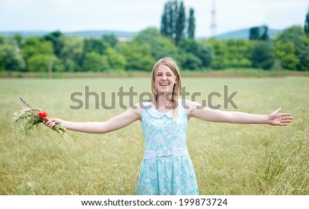 happy young woman arms up outdoors