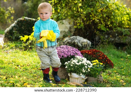 boy planting flowers in the garden