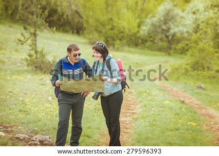 tourists with a map in the forest