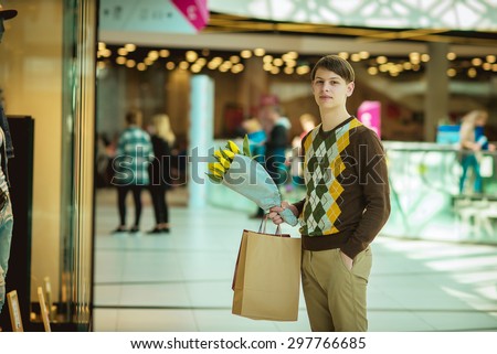 young man with a paper bag in a store