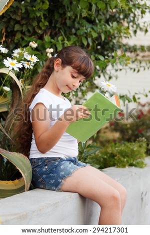 Cute Little School Girl  Reading Book Flower on background