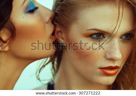 Luxurious weekend.concept. Beautiful couple of fashionable models with perfect arty make-up. Wet hair, waterproof decorative cosmetics. Close up. American disco (vintage) style. Outdoor fashion shot